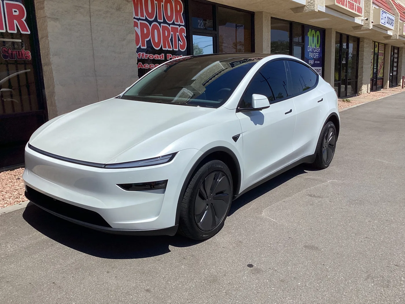 White Tesla outside Superior from Superior’s window tint photo collection in Ontario