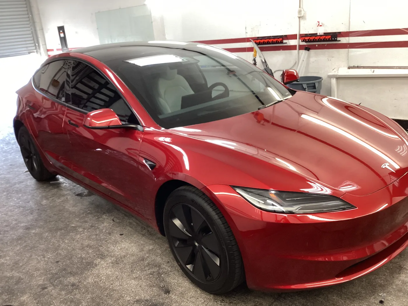 Red Tesla sedan from Superior’s window tint photo collection in Ontario